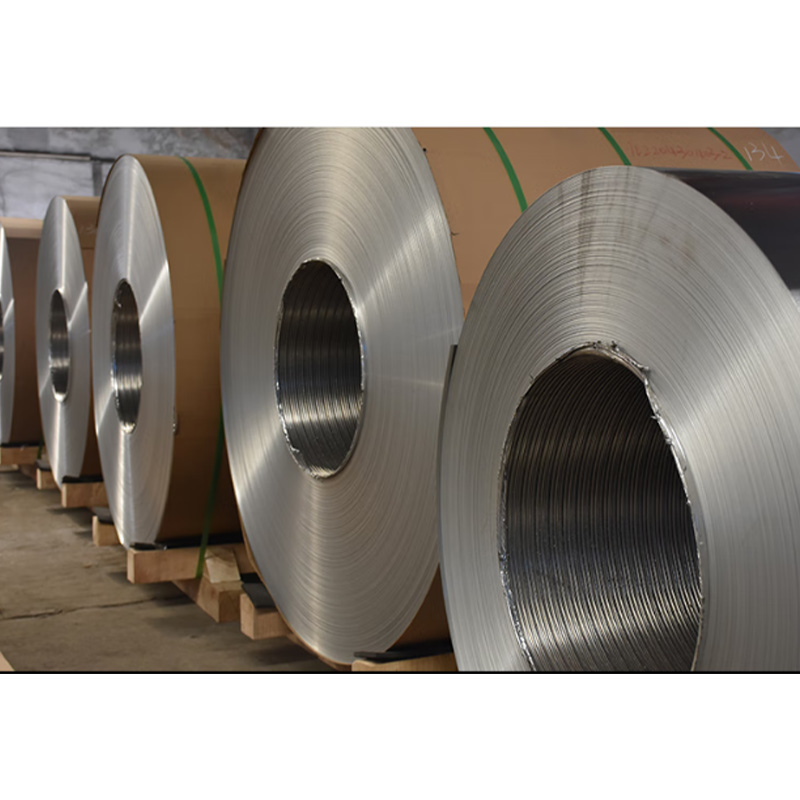 How should the temperature profile of aluminum coils of different thicknesses be optimized during annealing to reduce internal stress?